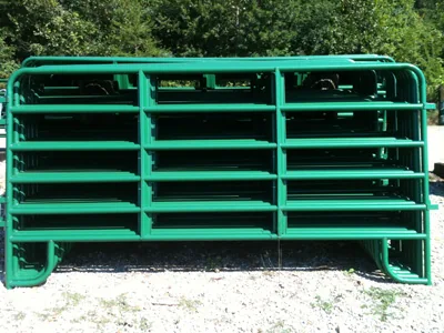 Green-painted steel corral panel standing in a Kentucky field